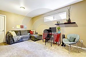 Basement room with couch and desk