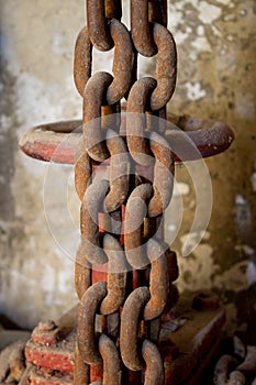 Basement, water valve, Old rusty chains hang on the background