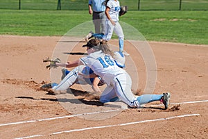 Baserunner diving back to the bag