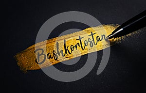 Bashkortostan Handwriting Text on Golden Paint Brush Stroke photo