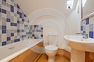 Basic compact bathroom with blue and white tiles