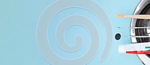 Basic dentist tools , toothbrush, toothpaste and Tooth model on blue Dental background