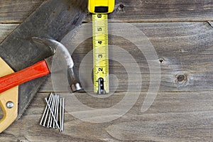 Basic home repair tools on weathered wood