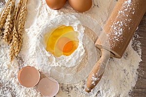 Basic ingredients for baking - eggs, dough, flour and rolling-pin.