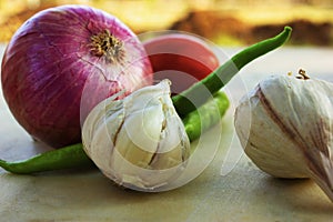 Basic ingredients for Indian curries, onion, garlic, tomato and chilly