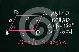 Basic parallelogram area formulas written on chalkboard