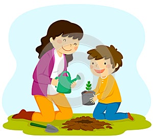 Woman and child planting a sapling photo