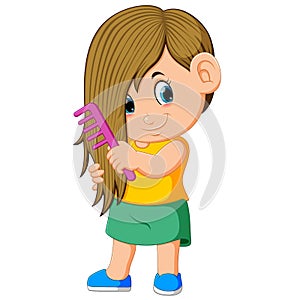 The girl is combing her hair with the pink comb photo