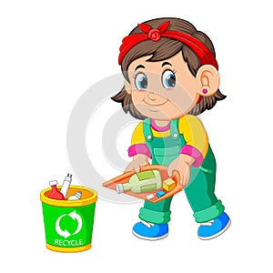 A girl keep clean environment by trush in rubbish bin photo