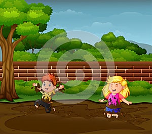 Happy kids playing in the mud