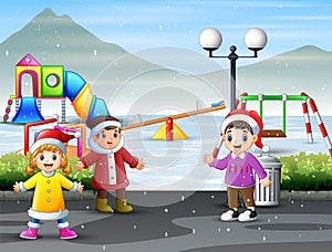Children playing at the snowy playground