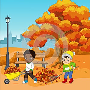 Cute kids volunteers Cleaning up Autumn Leaves in the City Park