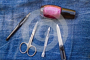Basic set of manicure tools on jeans background