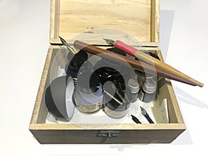 Basic traditional calligraphy tool set with ink in a wooden box