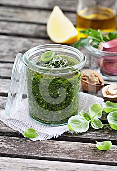 Basil pesto on a rustic wooden table