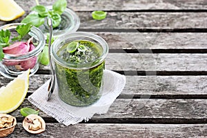 Basil pesto on a rustic wooden table