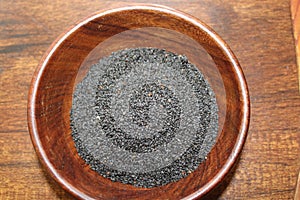 Basil seeds or sabja seeds in wooden bowl