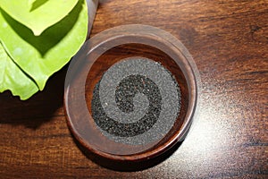 Basil seeds or sabja seeds in wooden bowl