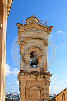 Semi-detail of one of the bell towers of the famous 17th-century neo-classical church of Mosta Rotunda. Malta, Europe