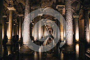 Basilica Cistern in Istanbul reflecting on water surface with illuminated columns