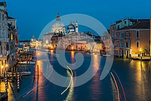 Basilica di Santa Maria della Salute and grand canal from Accademia Bridge at night in Venice, Italy photo