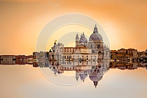 Basilica di Santa Maria della Salute reflected on the water surface, Venice, Italy.