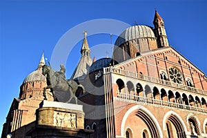 Basilica, in the evening sun, of Sant`Antonio in Padua. In the foreground, the monument dedicated to Gattamelata on horseback.