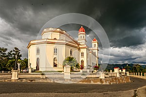 Basilica in honour of Our Lady of Charity, El Cobre with black thunder clouds above, Santiago de Cuba, Cuba