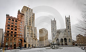 Basilica of Notre-Dame of Montreal and Place d`Armes on snow - Montreal, Quebec, Canada photo