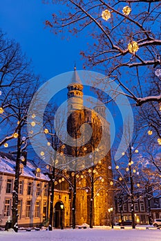 Basilica of Our Lady and the square during twilight, covered with snow