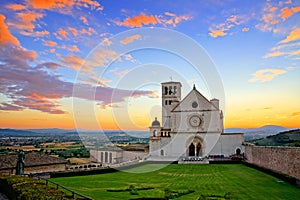 Basilica of San Francis of Assisi at sunset under beautiful orange and blue skies, Italy