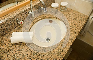 Basin and granite vanity in bathroom photo