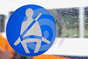 Basingstoke, UK - Jan 09 2016: Fasten seatbelt sign on the window of a public transport bus