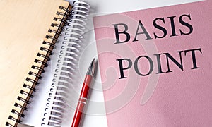 BASIS POINT text on pink paper with notebooks