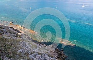 Baska - Aerial view of empty stone paradise beach in turquoise water lagoon in tourist town Baska, Krk Otok. Paradise lagoon