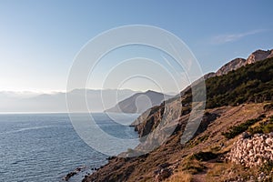 Baska - Coastal hiking trail along steep cliffs and mountains near tourist town Baska, Krk island, Primorje-Gorski Kotar