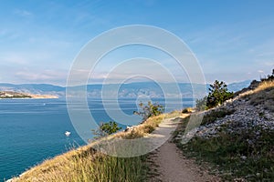 Baska - Idyllic hiking trail along rugged cliffs in coastal town Baska, Krk Island, Primorje-Gorski Kotar, Croatia, Europe