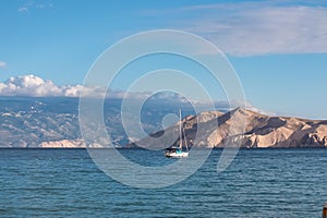 Baska - Small sailing boat cruising around archipelago near idyllic coastal town Baska, Krk Island, Primorje-Gorski Kotar