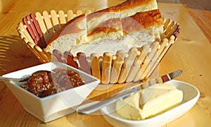 Basket of Armenian breads with Blurry homemade fig jam and butter in foreground