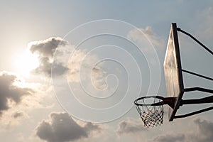 Basket ball board under sky with white clouds. Basketball court with old backboard. sky and white clouds on background.