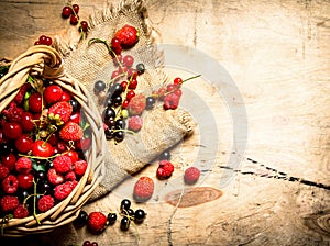 Basket with berries. On wooden table.