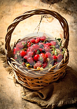 Basket with berries. On wooden table.