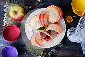 Basket berry muffin cake with apple jam still life wooden table decorated flowers capsules, molds