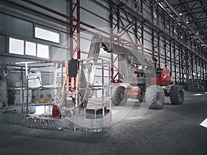 Basket of boom lift picker inside industrial building