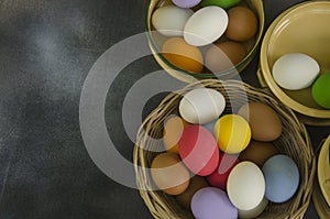 Basket and bowls of colored eggs top view