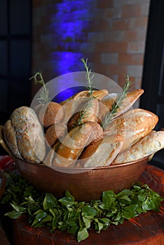 Basket with breads and sprigs of rosemary with blurs