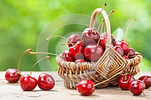 Basket with cherry close up on table