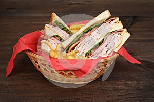 Basket of chicken club sandwich and fries