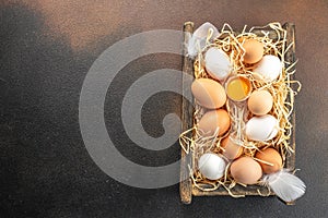 basket of chicken eggs on a dark background. top view