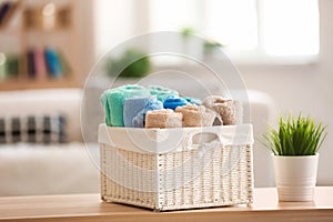 Basket with clean towels on table in room